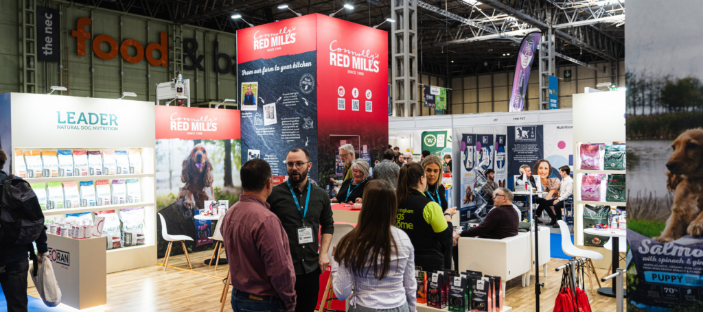 Visitors at the RED MILLS stand at a busy trade show