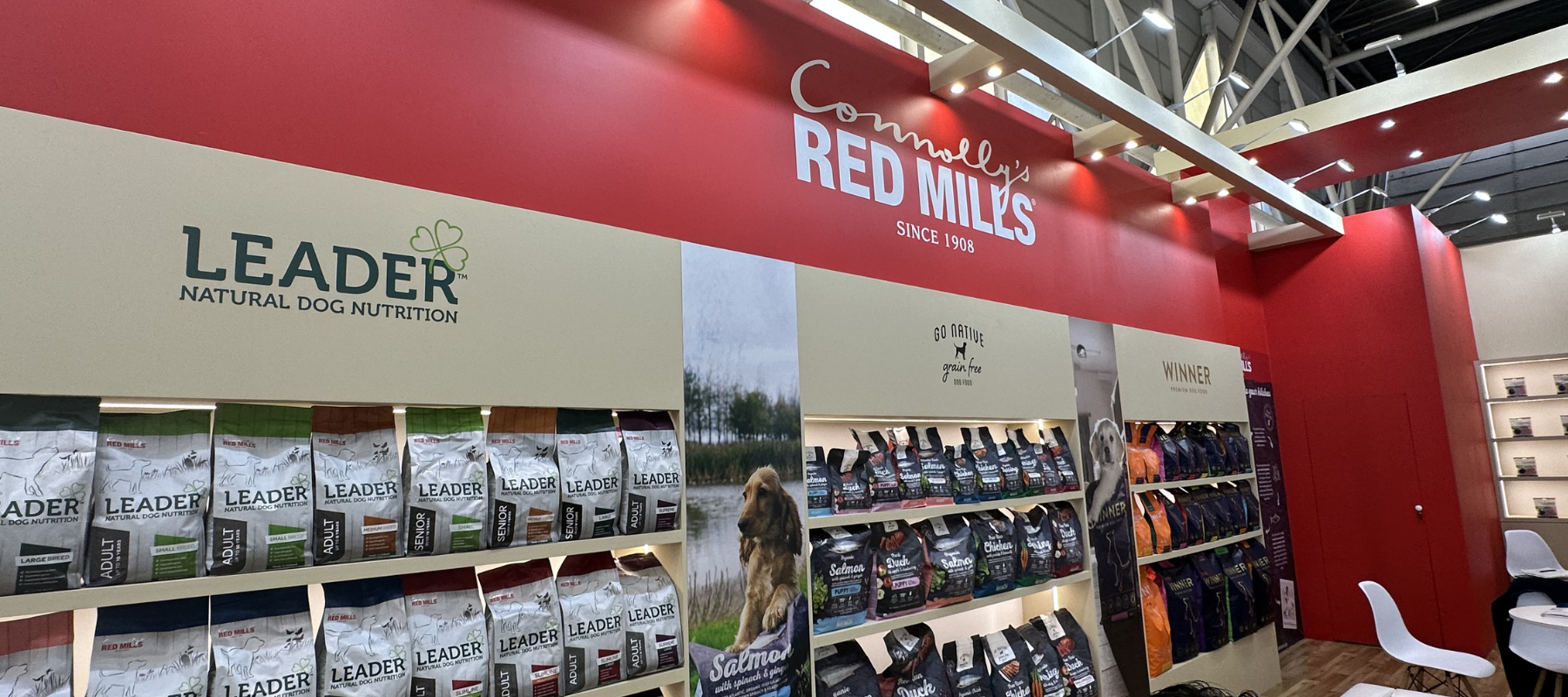 Leader and RED MILLS trade show stand with shelves of dog food